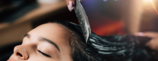 Hairdresser Treating Woman’s Hair with Revitalizing Hair Pack