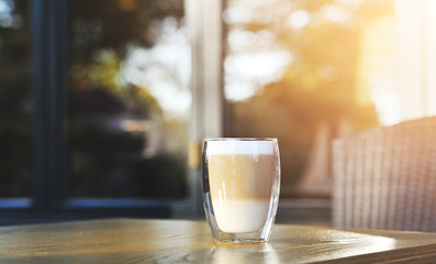 Cup of cappuccino on wooden background.