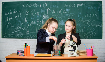 Science concept. Gymnasium students with in depth study of natural sciences. Girls school uniform busy with proving their hypothesis. Private school. School project investigation. School experiment