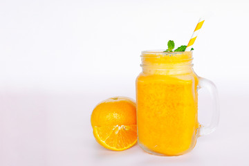 Orange smoothies yellow colorful fruit juice milkshake blend beverage healthy high protein the taste yummy In glass,drink to lose weight drink episode morning on white gray background.