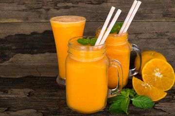 Orange juice fruit smoothies yogurt drink yellow healthy delicious taste in a glass slush for weight loss on wooden background.
