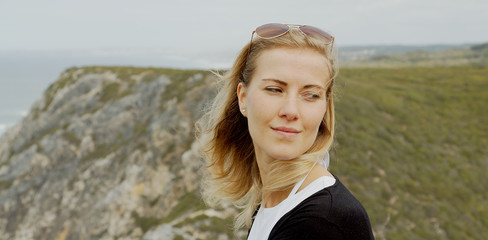 Beautiful woman relaxes at Cabo da Roca in Portugal - Sintra Natural Park - travel photography