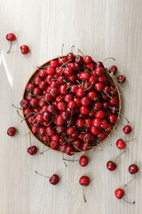 Fresh sweet Cherry on a wooden plate on a table. Natural organic food.