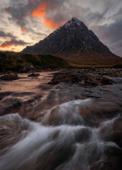 The Buachaille is a mountain in Glencoe, Scotland, the river in the for ground is the Coupall. Photo was taken during sunset with a slightly slower shutter speed. Glencoe is a area in the highlands.