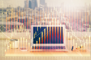 Financial chart drawing and table with computer on background. Multi exposure. Concept of international markets.