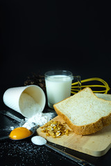 Fresh bread and ingredients flour, egg, sugar, milk and Grains. Close up shot.