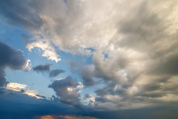 Blue sky covered with white puffy clouds.