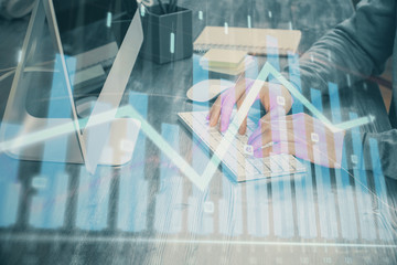 Double exposure of financial graph with man works in office on background. Concept of analysis.
