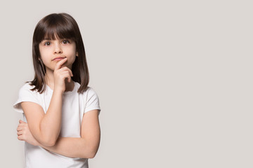Close up portrait with thoughtful little brown-haired girl.