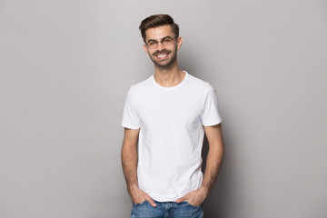 Portrait with smiling handsome bearded man in t-shirt and eyewear.