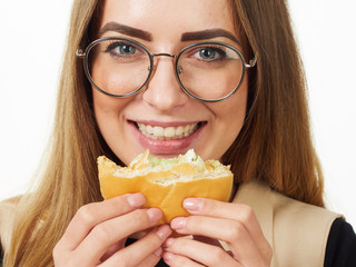 girl eating a burger on a white background