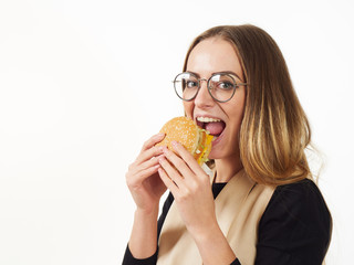 girl eating a burger on a white background