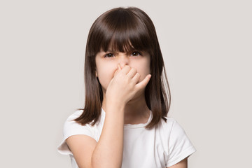 Close up portrait with shocking little brown-haired girl.