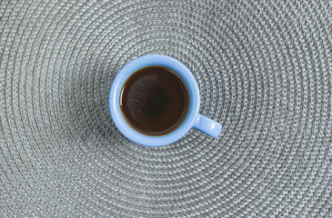 Blue cup of coffee on the gray background, flat lay