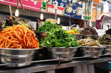 Preparing bibimbap ingredients in stainless bowl