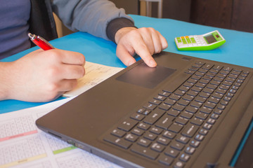 man hand holding ballpoint pen working on computer, working online concept