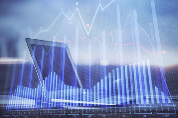 Financial graph colorful drawing and table with computer on background. Multi exposure. Concept of international markets.