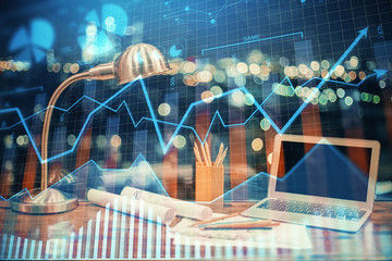 Double exposure of chart and financial info and work space with computer background. Concept of international online trading.