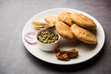 Fried Sattu Litti chokha served with Baingan Bharta, onion and pickle, popular recipe from Bihar, India