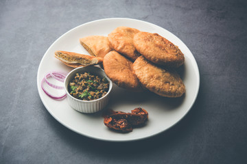 Fried Sattu Litti chokha served with Baingan Bharta, onion and pickle, popular recipe from Bihar, India