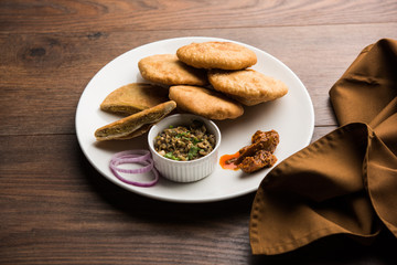 Fried Sattu Litti chokha served with Baingan Bharta, onion and pickle, popular recipe from Bihar, India