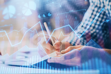 Multi exposure of two men planing investment with stock market forex chart.