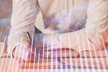 Financial trading chart double exposure with man desktop background.