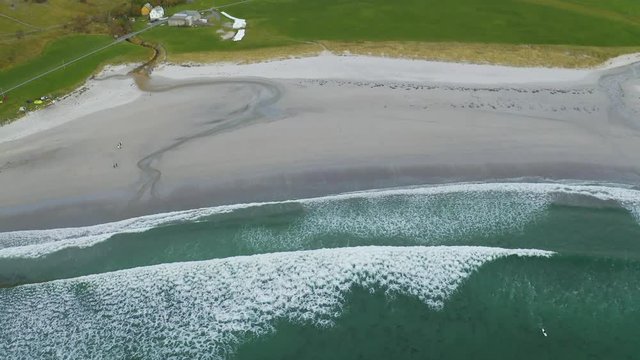 4K drone footage of wave hitting the beach in Norway