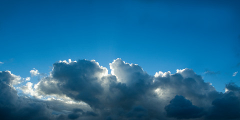 Fototapeta na wymiar Atmospheric sky art image. A sky cloudscape scene, with well developed white and grey Cumulonimbus cloud in a mid blue sky. Australia.