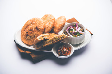 Fried Sattu Litti chokha served with Baingan Bharta, onion and pickle, popular recipe from Bihar, India