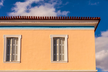 Old window shutters on orange home