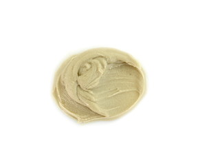 Tahini sauce (sesame seed paste) isolated on white background. Tahini paste smeared on a white surface.