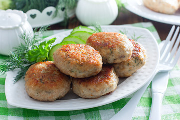 Fried fish cakes on a white plate with rice, horizontal