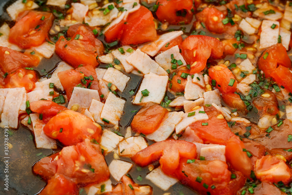 Wall mural consecutive steps of preparing scrambled eggs with tomatoes and ham, seasoned with herbs