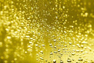 Drops of water on a glass background. Gold. Selective focus. Toned