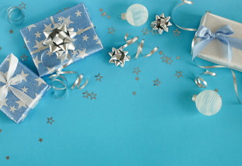 Christmas background top view. Xmas or new year blue silver color decorations and gift boxes on blue  background with empty copy space for text.  holiday concept. copy space