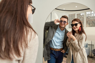 Fototapeta premium Adult woman and man wearing sunglesses and smiling nice