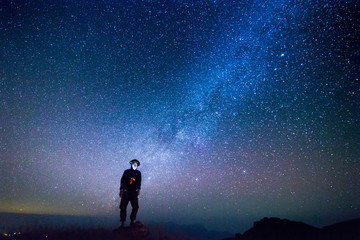 Landscape with Milky way, Milky way background, Night sky with stars and galaxy over night sky and silhouette of a standing people in Thailand