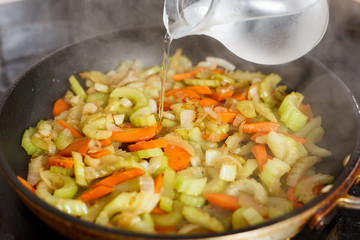 the process of cooking vegetables in a pan