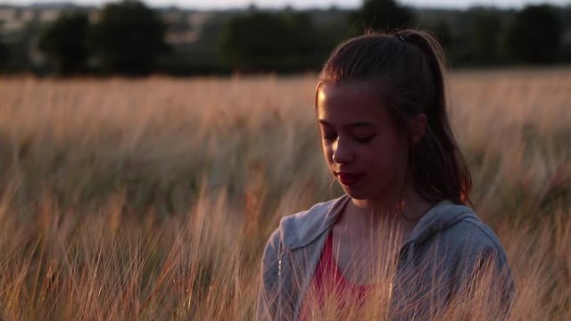 Gluten Free Teenage Girl In Barley Field In Cotswolds Showing Barley Head To Camera With No Go Sign, Stop Symbol Graphic