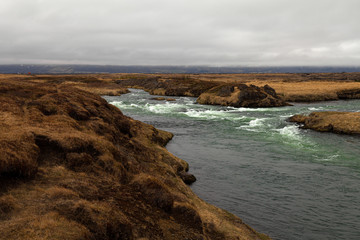 River and stunted grass on a dramatic landscape of Iceland