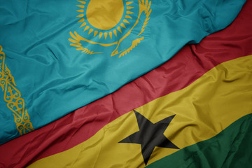 waving colorful flag of ghana and national flag of kazakhstan.