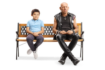 Fototapeta na wymiar Punk man sitting on a bench with a little boy