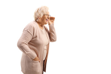 Cheerful elderly woman whispering