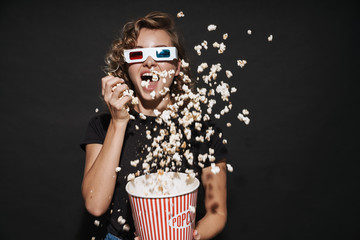 Happy cute young woman eat popcorn watch cinema. - obrazy, fototapety, plakaty