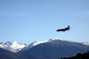 Fototapeta na wymiar plane flying over snow-covered mountain peaks