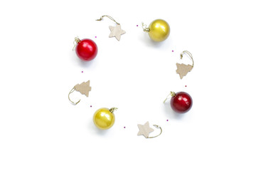 minimalistic christmas composition. Round festive frame on a white background with Christmas decorations, gold and red shiny ball, stars sparkles. top view, copy space, happy new year concept