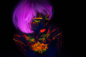 Portrait of Beautiful Fashion Woman in Neon UF Light. Model Girl with Fluorescent Creative Psychedelic MakeUp, Art Design of Female Disco Dancer Model in UV, Colorful Abstract Make-Up. Dancing Lady