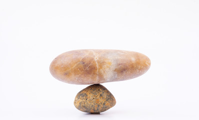 Fototapeta na wymiar A picture of a rock placed together with a balanced weight on a white background.