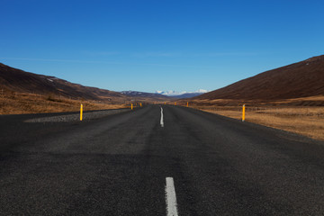 Fototapeta na wymiar Road on a calm deserted spring landscape of Iceland
